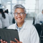 Portrait, scientist and happy woman in laboratory with tablet for medical research and job as biolo
