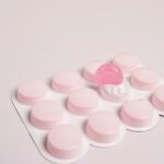 cough lozengers over white background, pink pills
