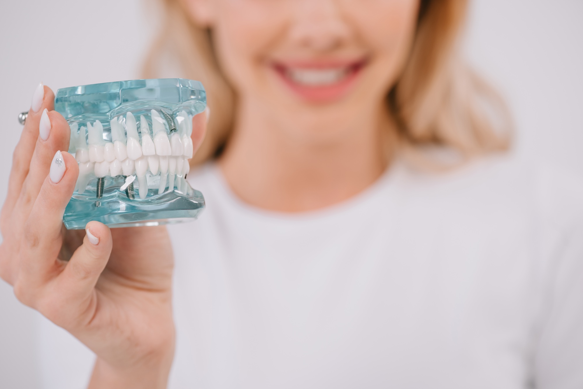 selective focus of jaw model with woman on background isolated on white with copy space